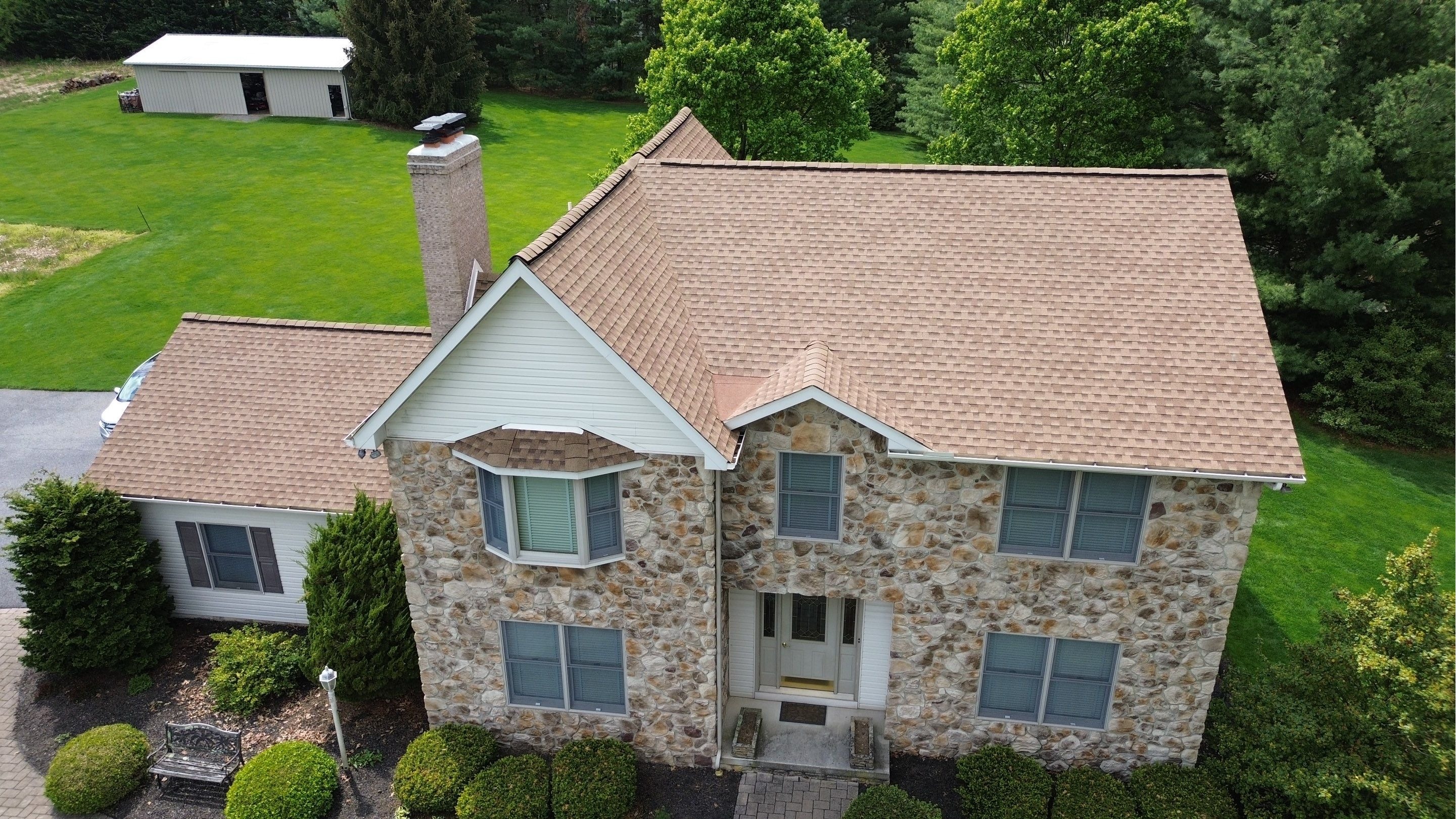 Completed architectural shingle roof replacement in Westminster, Maryland, shown from the front elev 