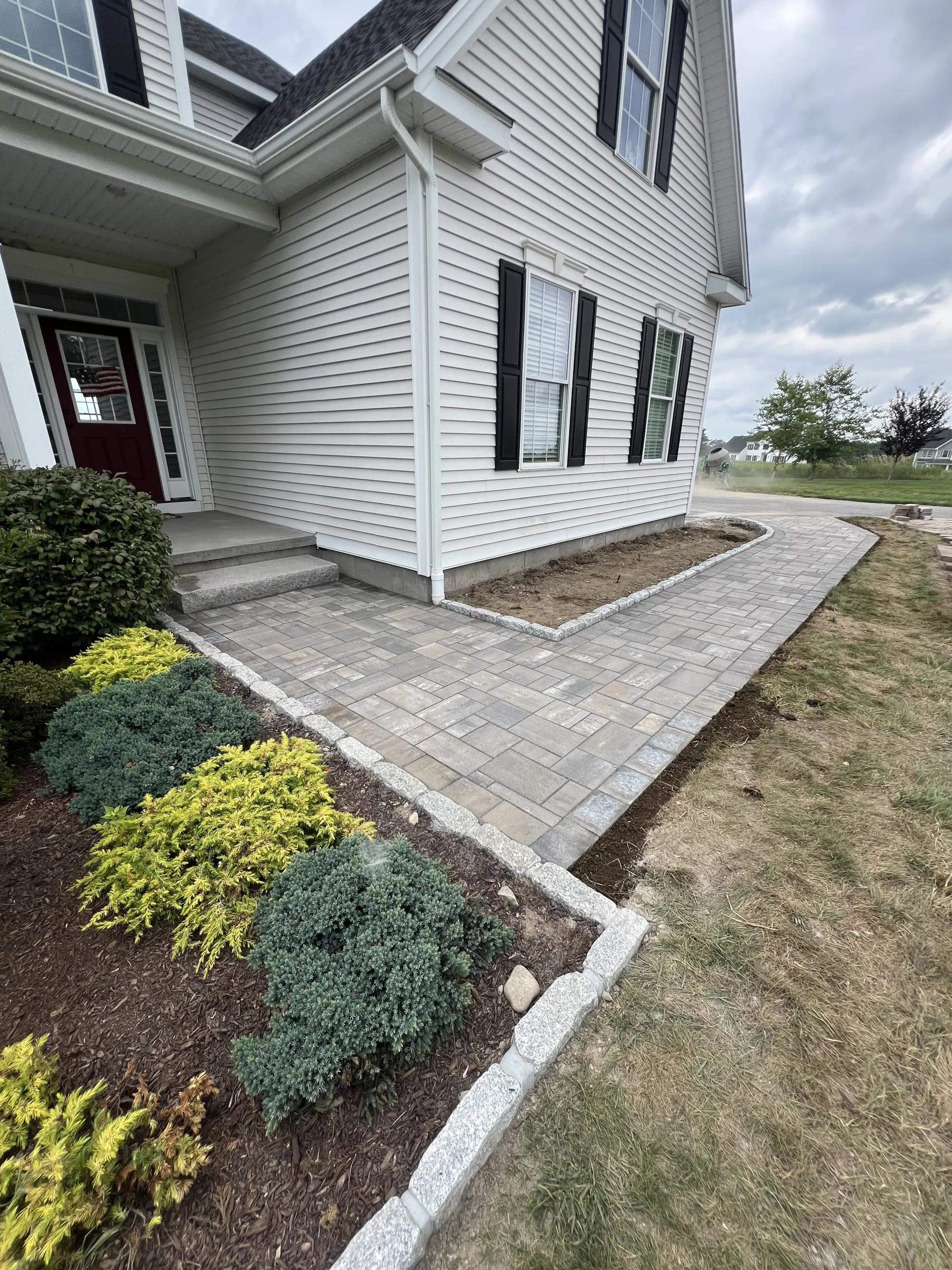Stone walkway with clean borders - Walkways and pathways project by General Masonry LLC.