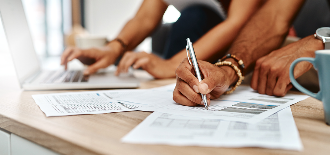 Close-up of clients filling out documents.