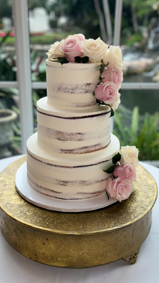 Rustic wedding cake with fresh flowers from the best bakery in Deerfield Beach. 