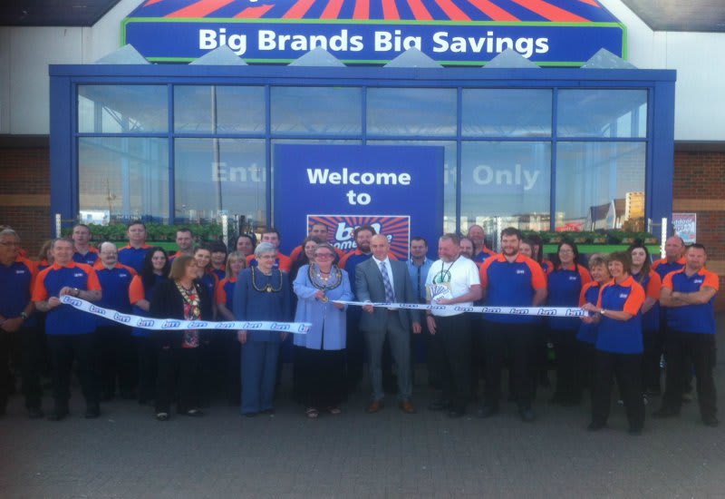 Mayor of Barrow, Councillor Ann Thomson cuts the ribbon on B&M's new store on Hindpool Road. She is joined by representatives from the store's chosen charity, Great North Air Ambulance.