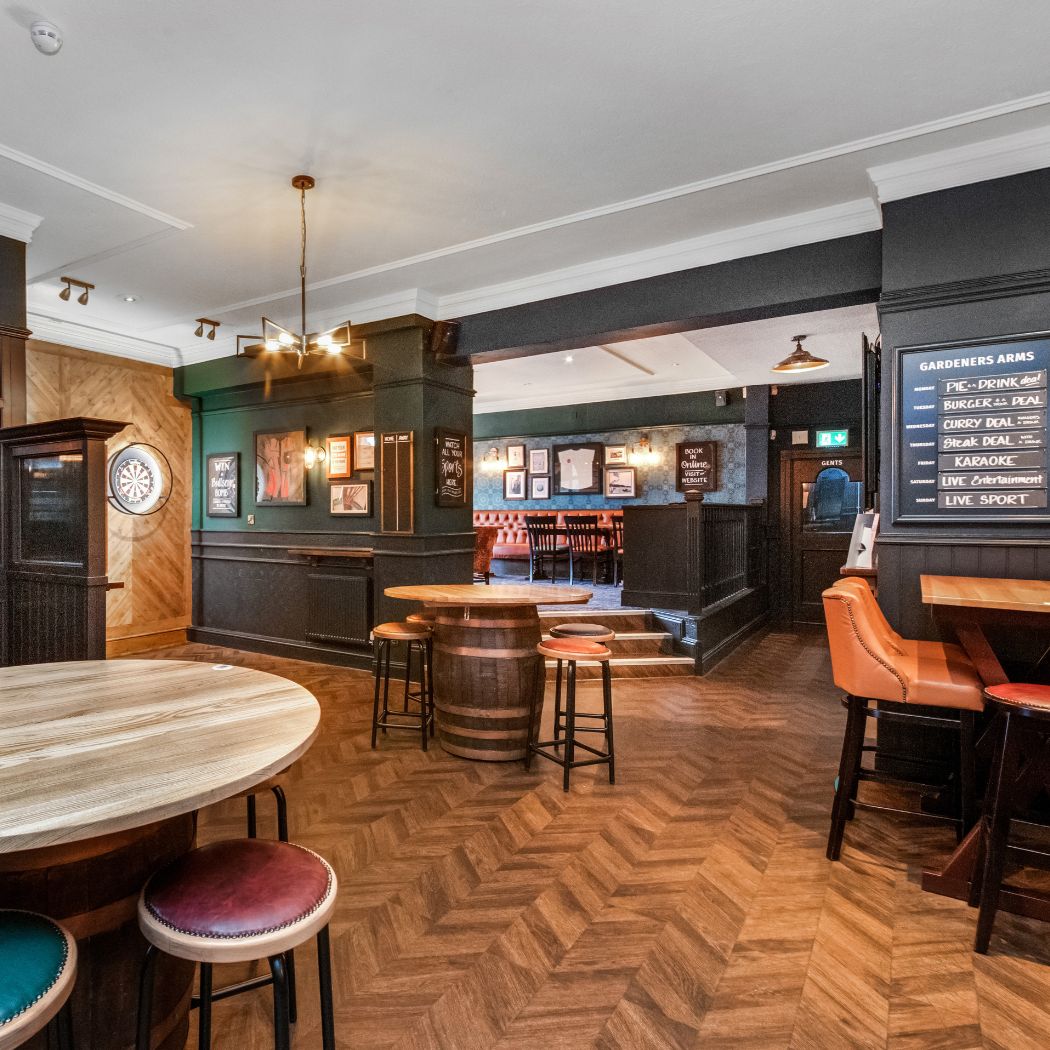 Open-plan seating area with high tables and booth seating, ideal for dining, drinks and group visits.