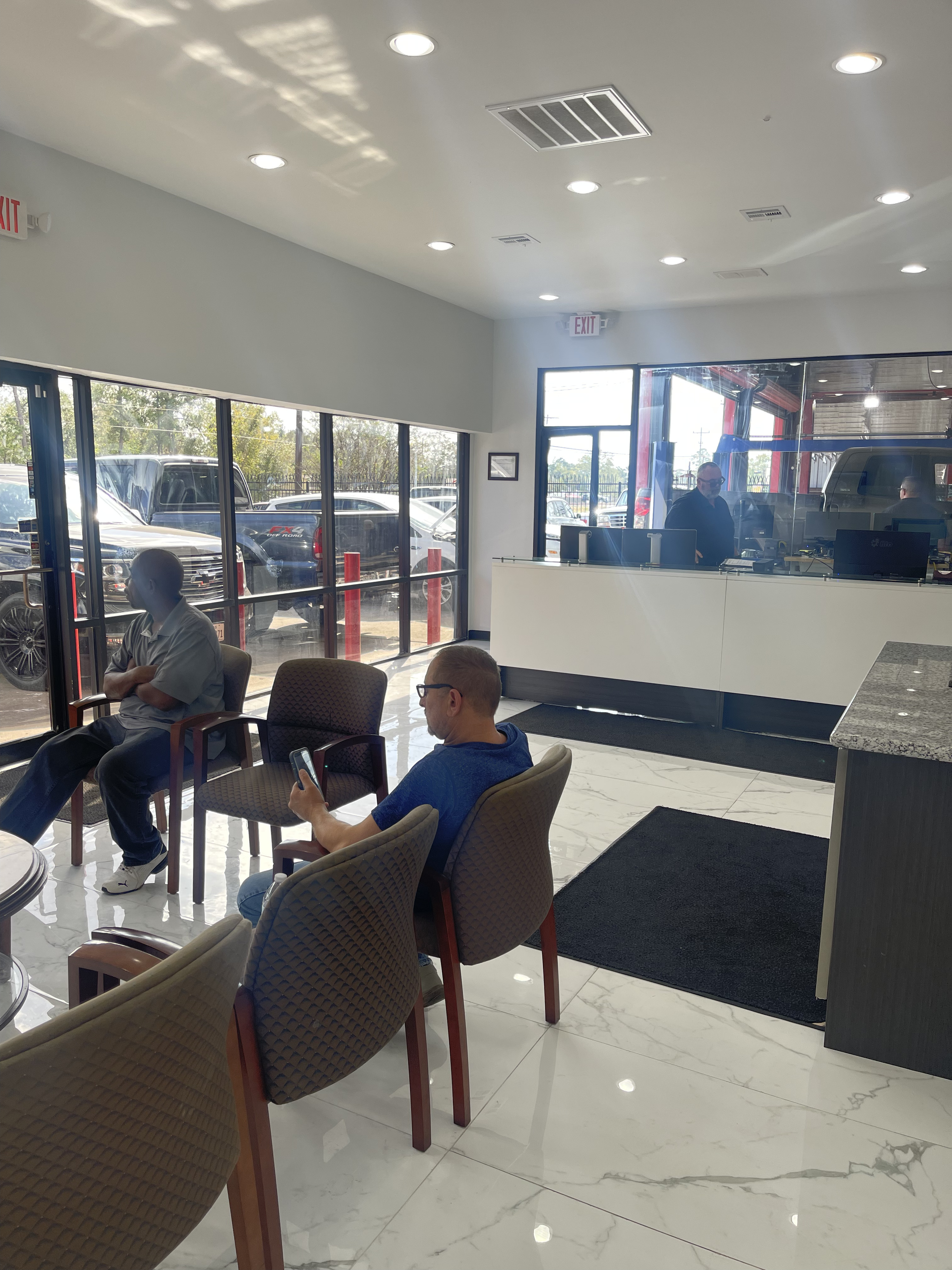 Modern customer waiting area at Yes! Automotive in Porter, TX, featuring comfortable seating, a clean lobby, and a convenient service counter for a welcoming auto repair experience.