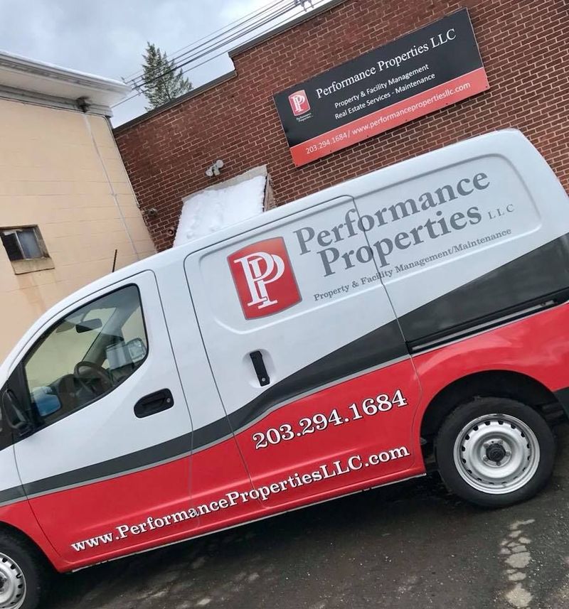 Performance Properties LLC office exterior displaying branded company signage above the entrance. The image represents professional property and facility management services, real estate maintenance solutions, and a trusted commercial presence serving residential and business property clients in the community.