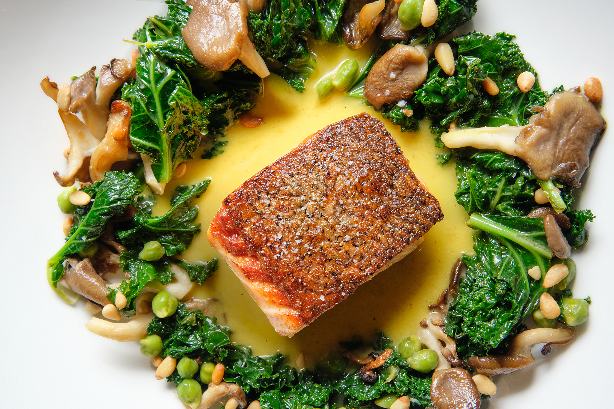 seared salmon, caper dill saltza, pine nuts, green chickpeas 