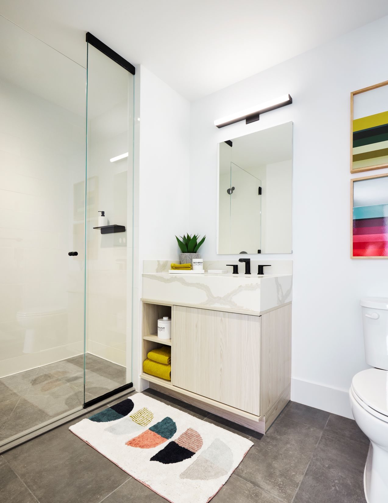 Modern bathrooms featuring glass doors and ceramic tile in showers.