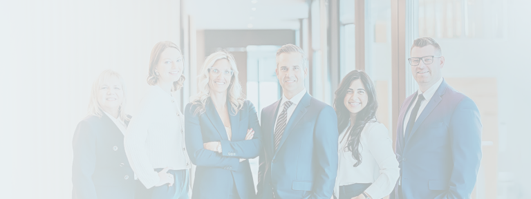 The Bogle Private Wealth Group team standing side by side in their office.