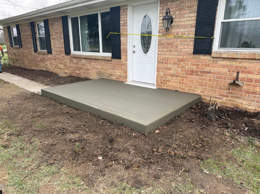 This house in Maineville needed a new porch. The homeowners didn't want anything fancy. Just a basic concrete porch. We do those, too. After removing the old one, we poured this new slab and gave it a broom finish to reduce slips. Do you need a new porch? Call today for your FREE estimate.