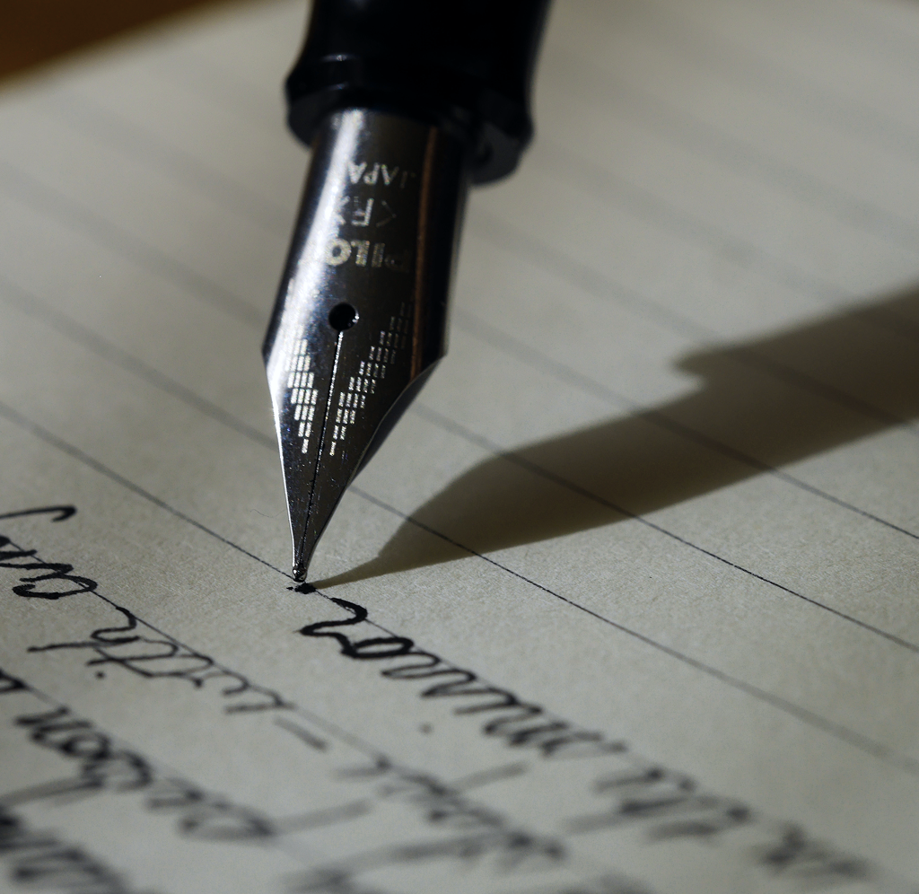 A pen writing on paper.