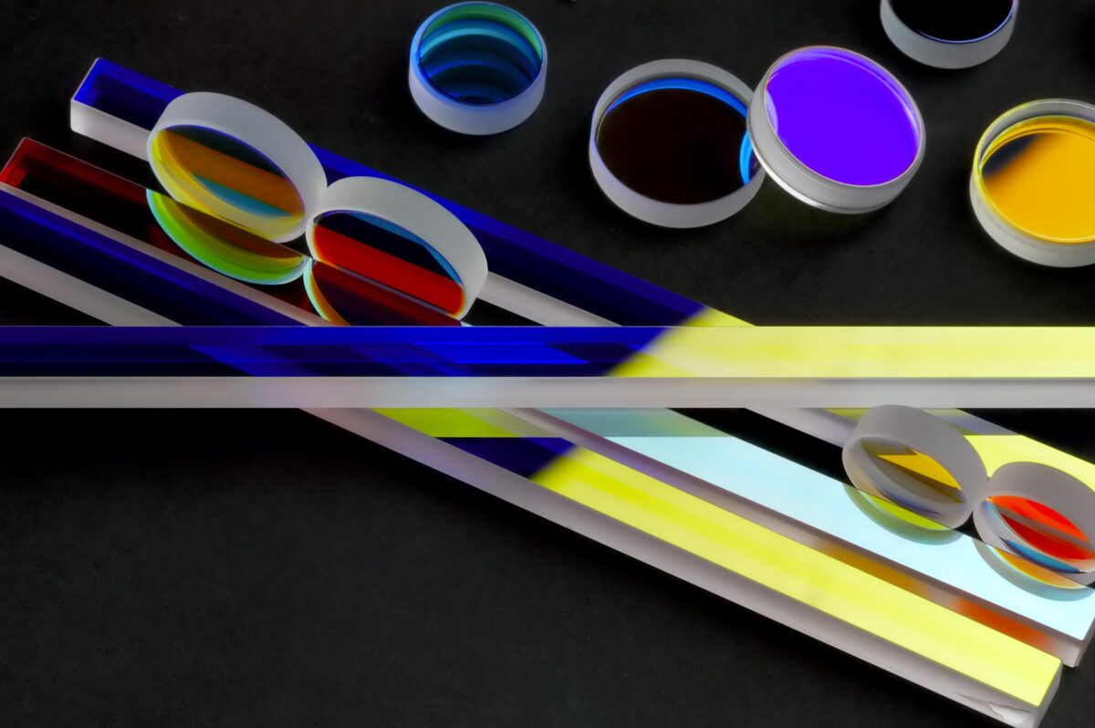 Complete range of precision optical components showcasing DSI's full-spectrum coating capabilities from UV through very long-wave infrared (up to 22 μm). Product assortment includes colored bandpass filters, dichroic mirrors, beamsplitters, cold/hot mirrors, and custom antireflection coatings for aerospace, defense, commercial, medical, and scientific applications manufactured with space-heritage quality standards.