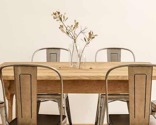 A wooden dining table surrounded by metal chairs.