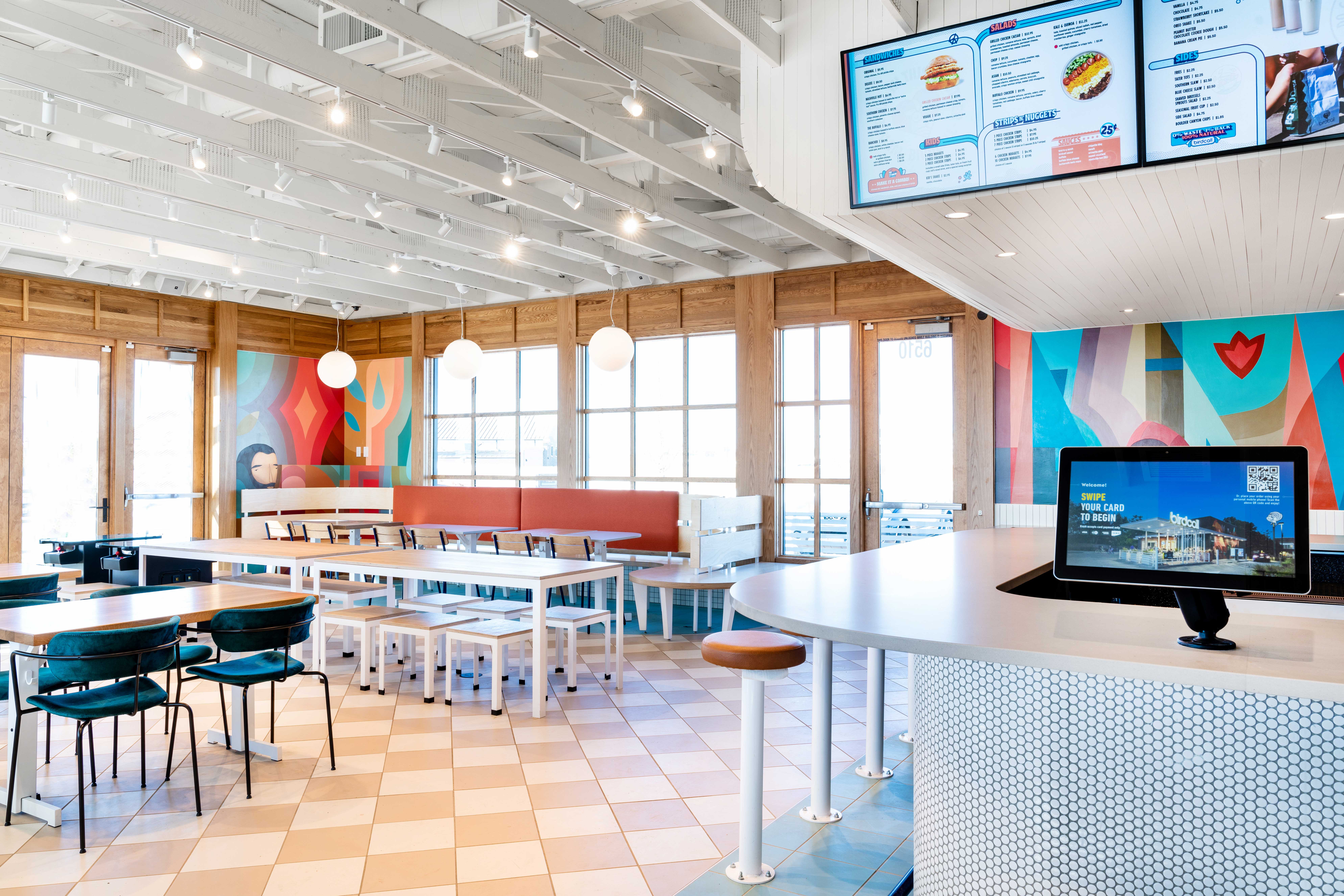 Interior of Birdcall Colorado Springs, highlighting the spacious dining room and ordering system.