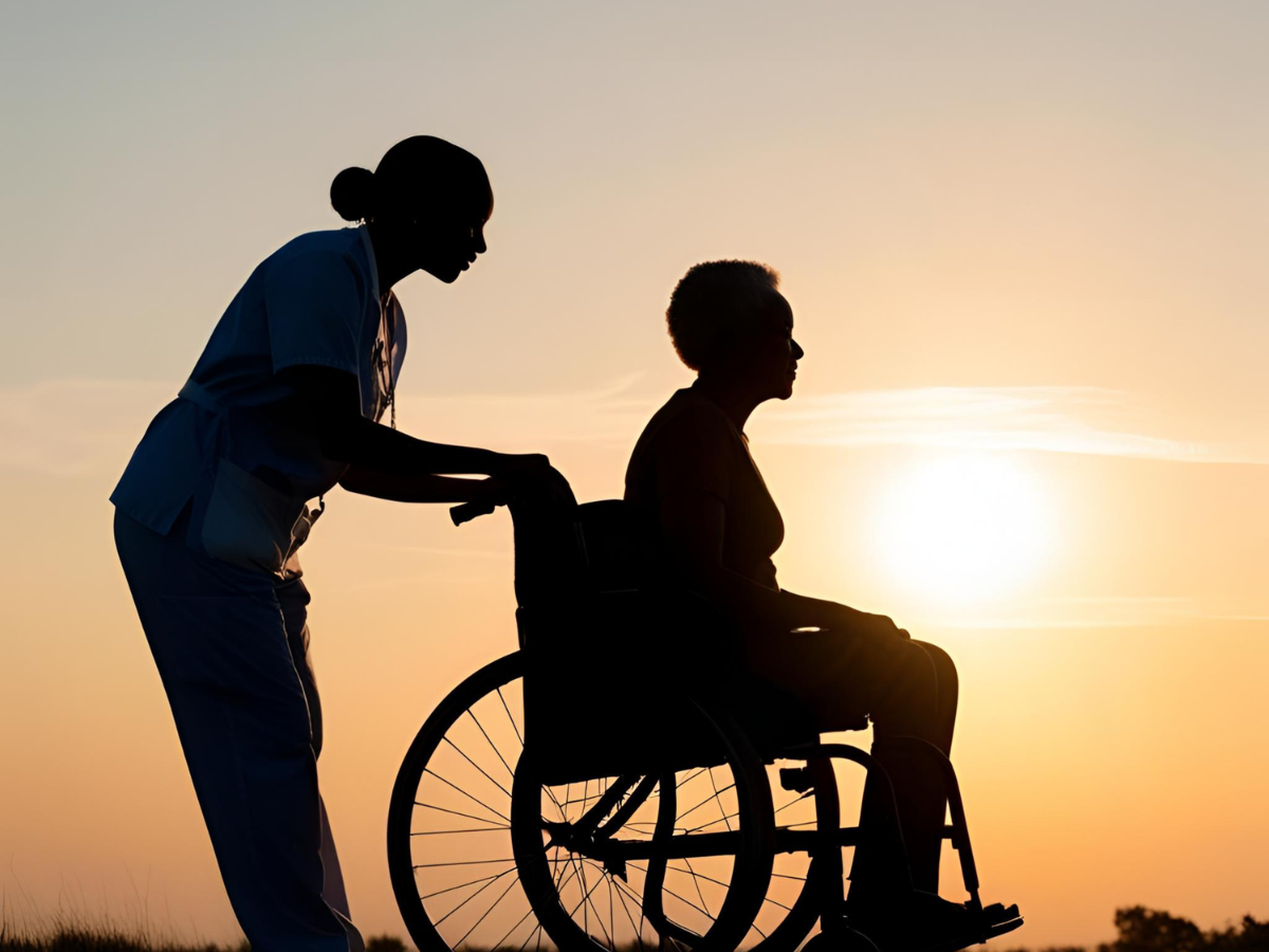 Caregiver assisting a senior in a wheelchair during in-home care services.