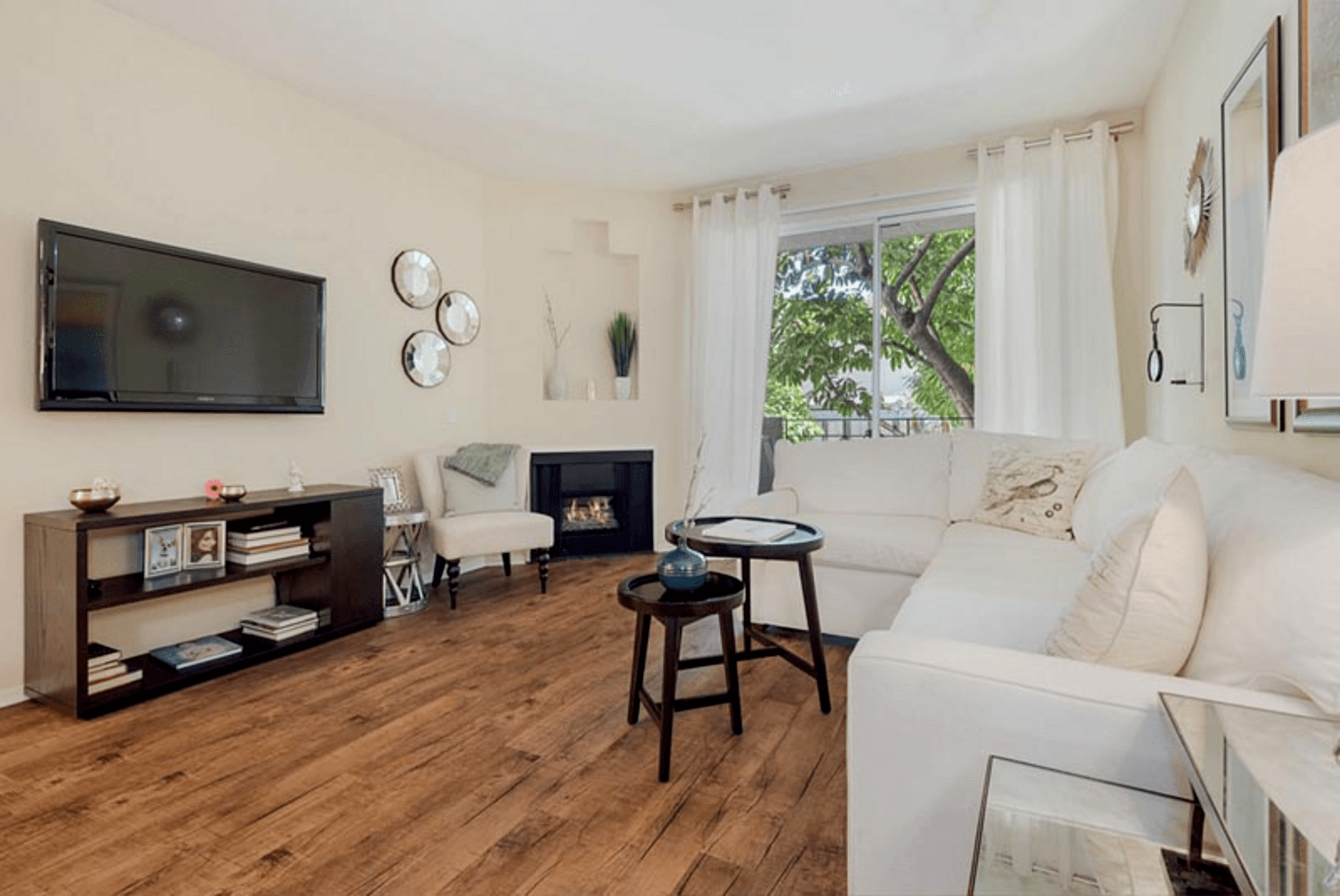 A living room with a fireplace and a television.