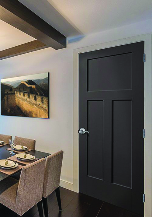 Custom black painted interior door with a clean paneled design installed in a contemporary dining space.