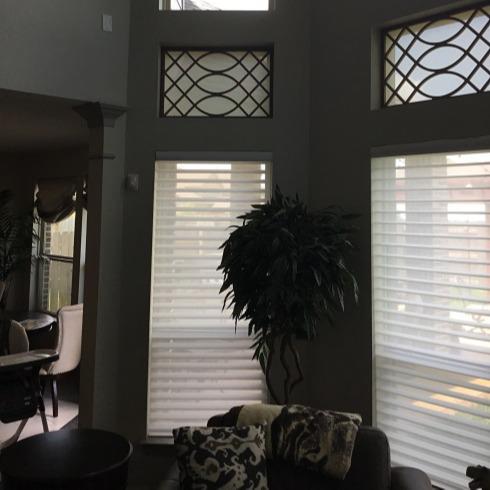 Upgrade the look of your Katy, TX home using Hunter Douglas Silhouettes with contemporary Tableaux Faux Iron Treatments in the transom windows. Each Faux Iron Window Treatment has a solar screen on the back to keep the heat and UV rays out and let the light and view still come through. #BudgetBlinds