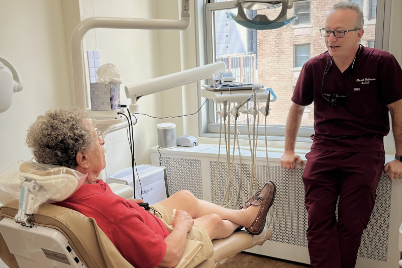 Dr. Mitchell Rubinstein of Studio 57 Dental discussion dental care with a patient