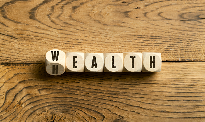 Dice spelling out "wealth."