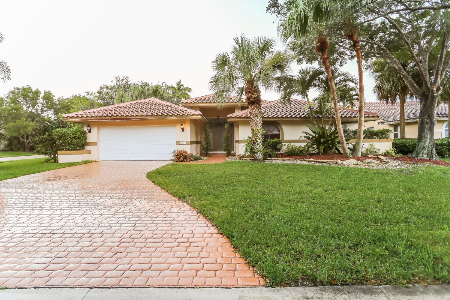 Beautiful Invitation Homes property with extended driveway and garage in South Florida.