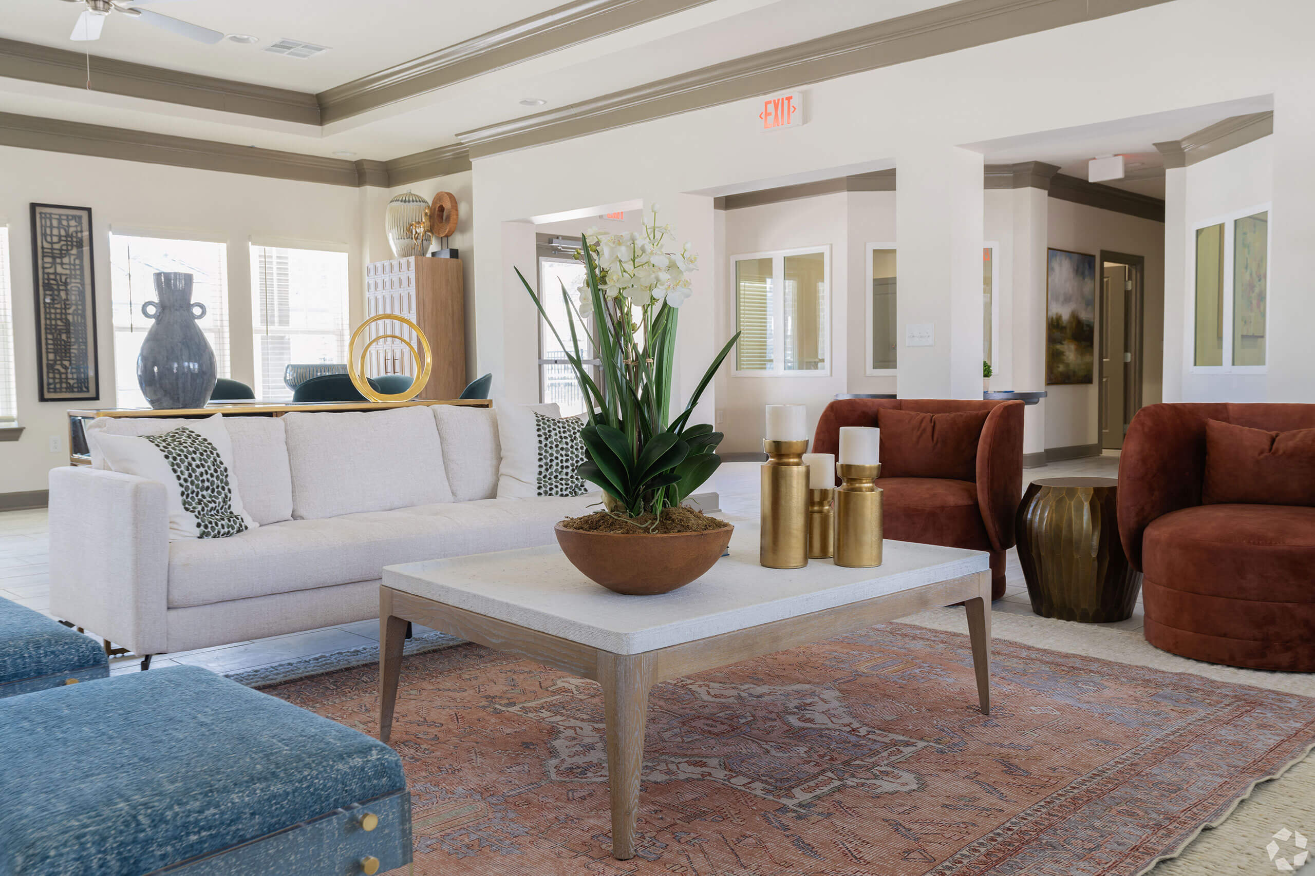A living room with a white couch, a coffee table, and a rug.