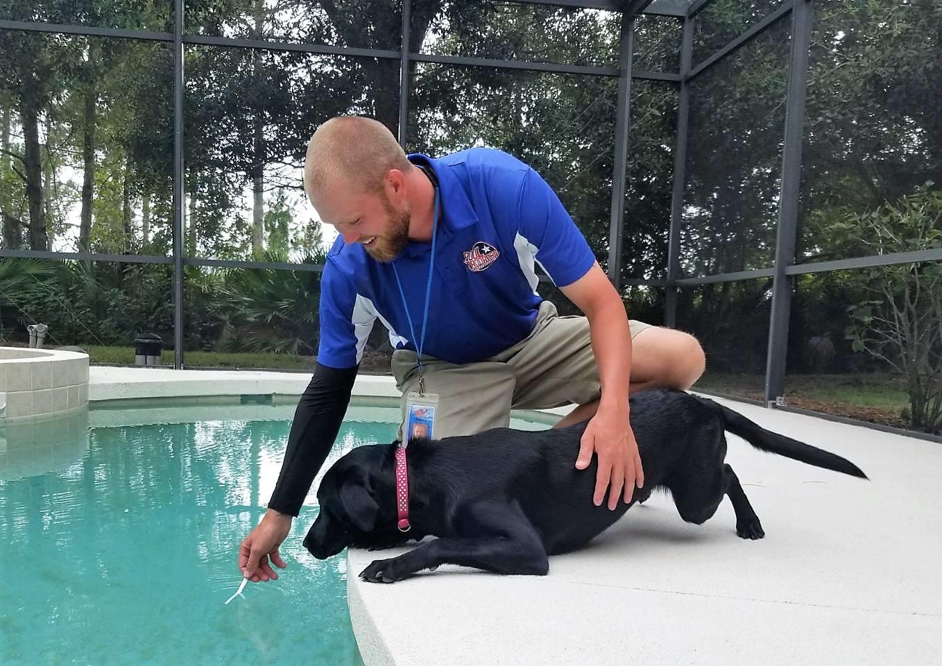 Pool Troopers Technician Servicing a Pool with the Help of a Customer's Dog Pool Troopers Cypress (281)358-1876