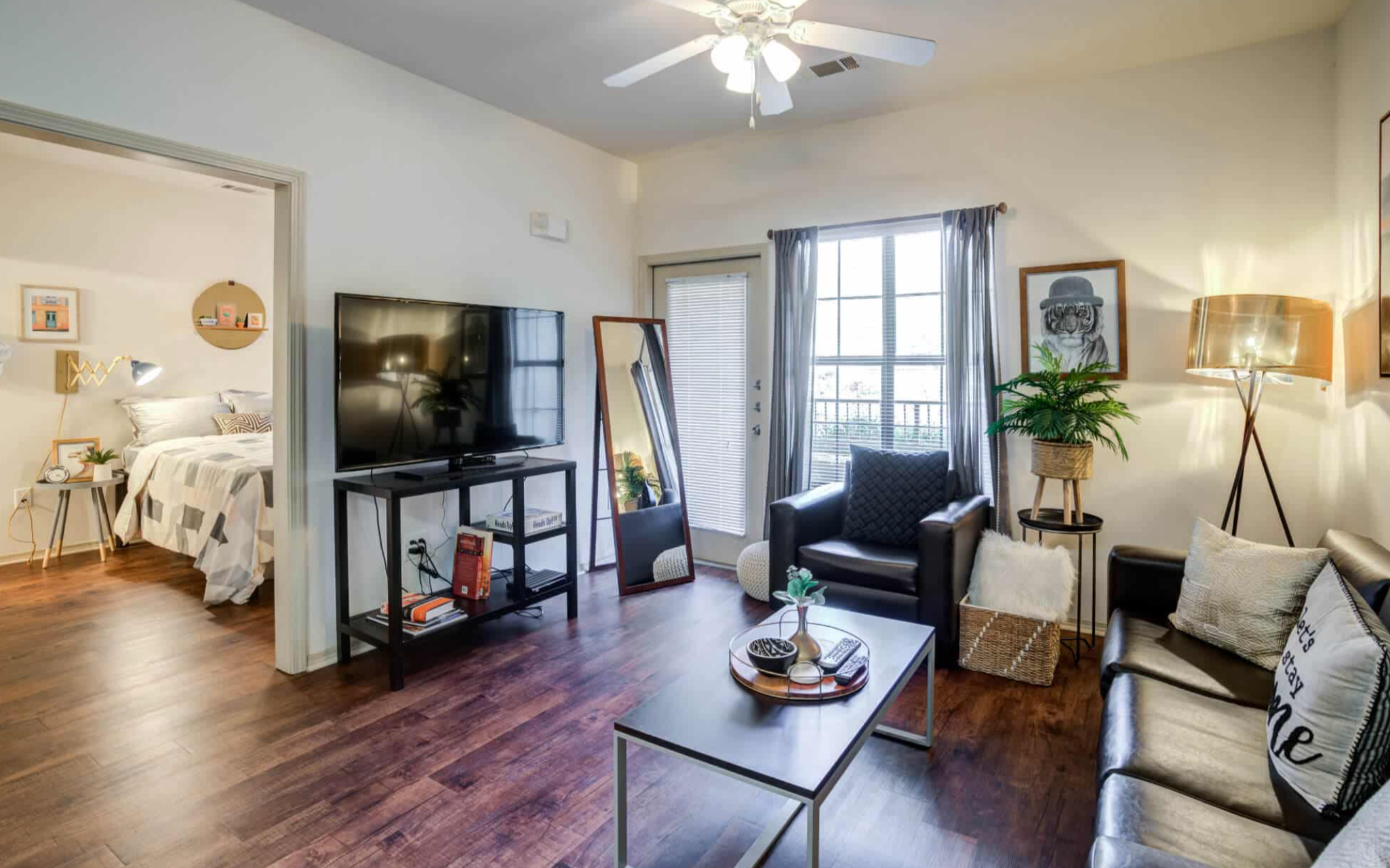 Spacious living room furnished and with hardwood flooring