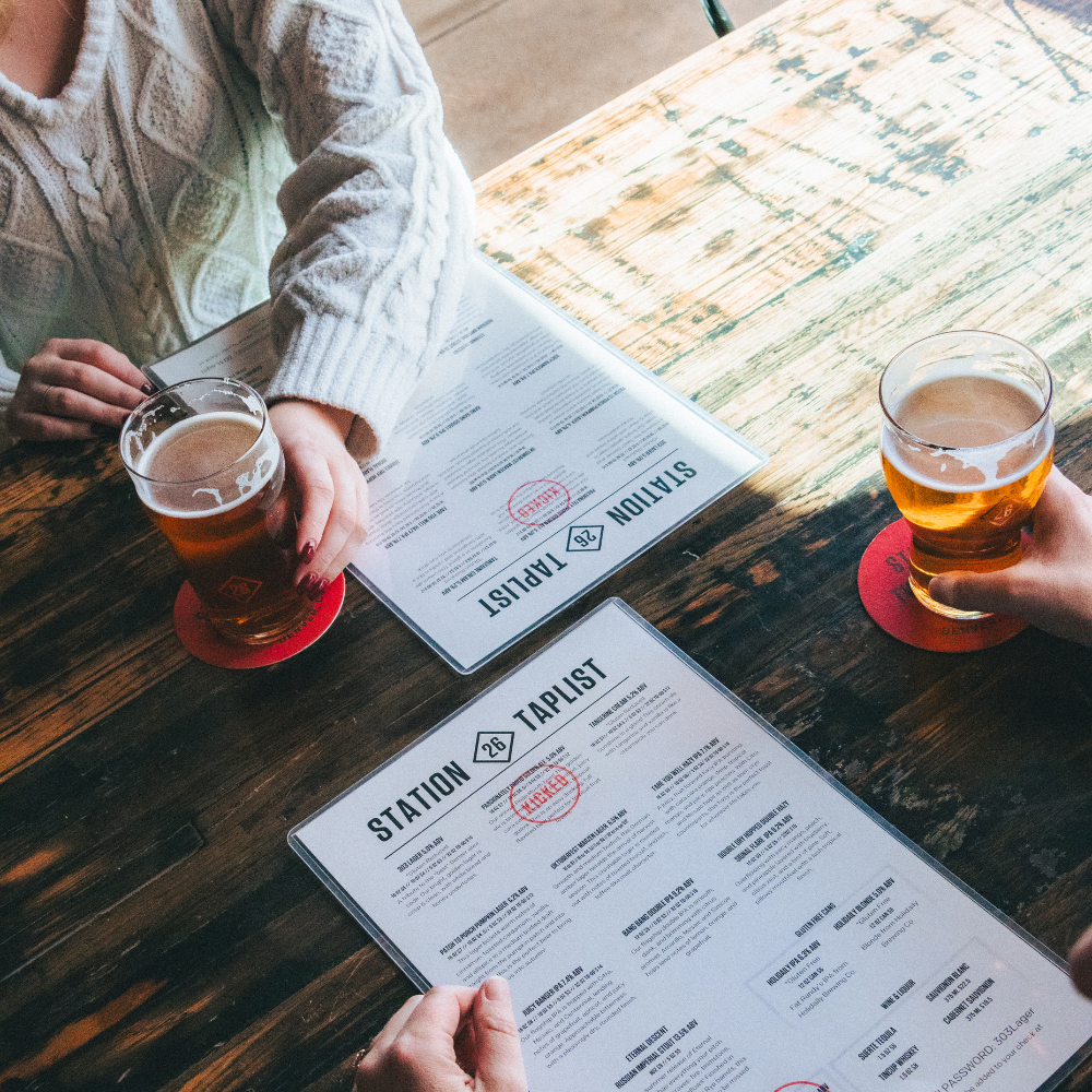 Guests review the taplist while enjoying fresh Colorado craft beer at Station 26 Brewing Co. 