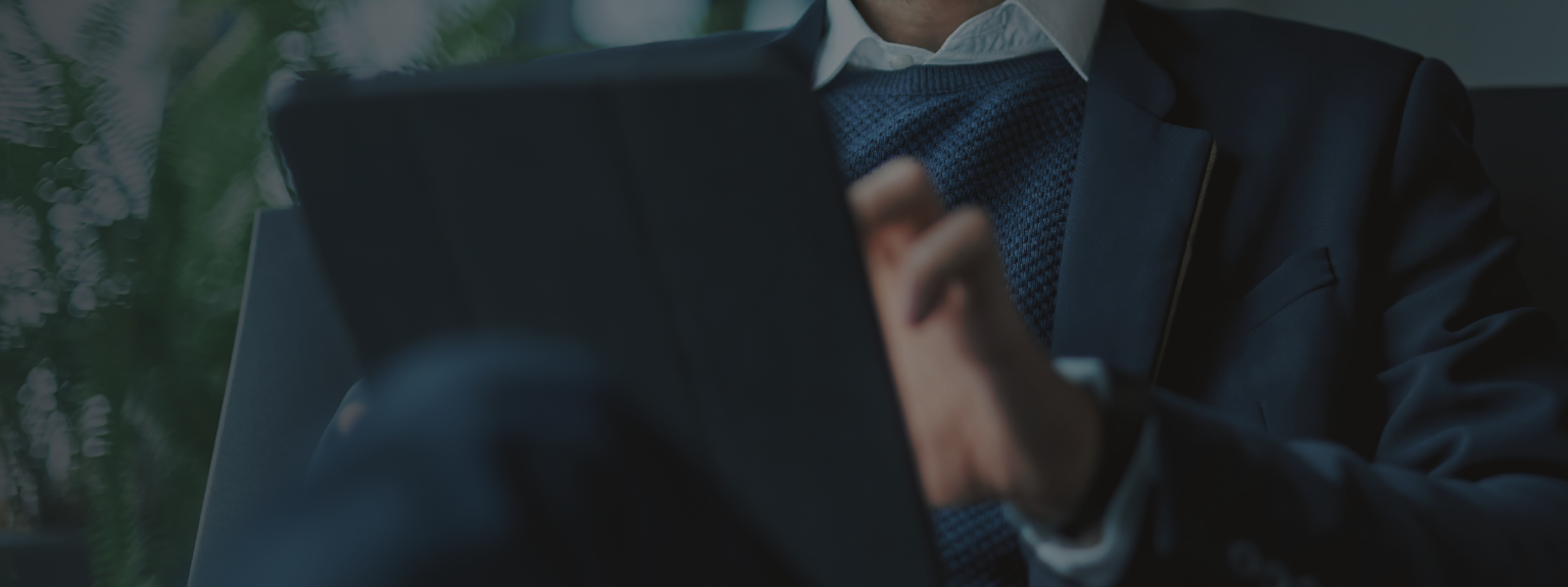 Close up of a man on his tablet.