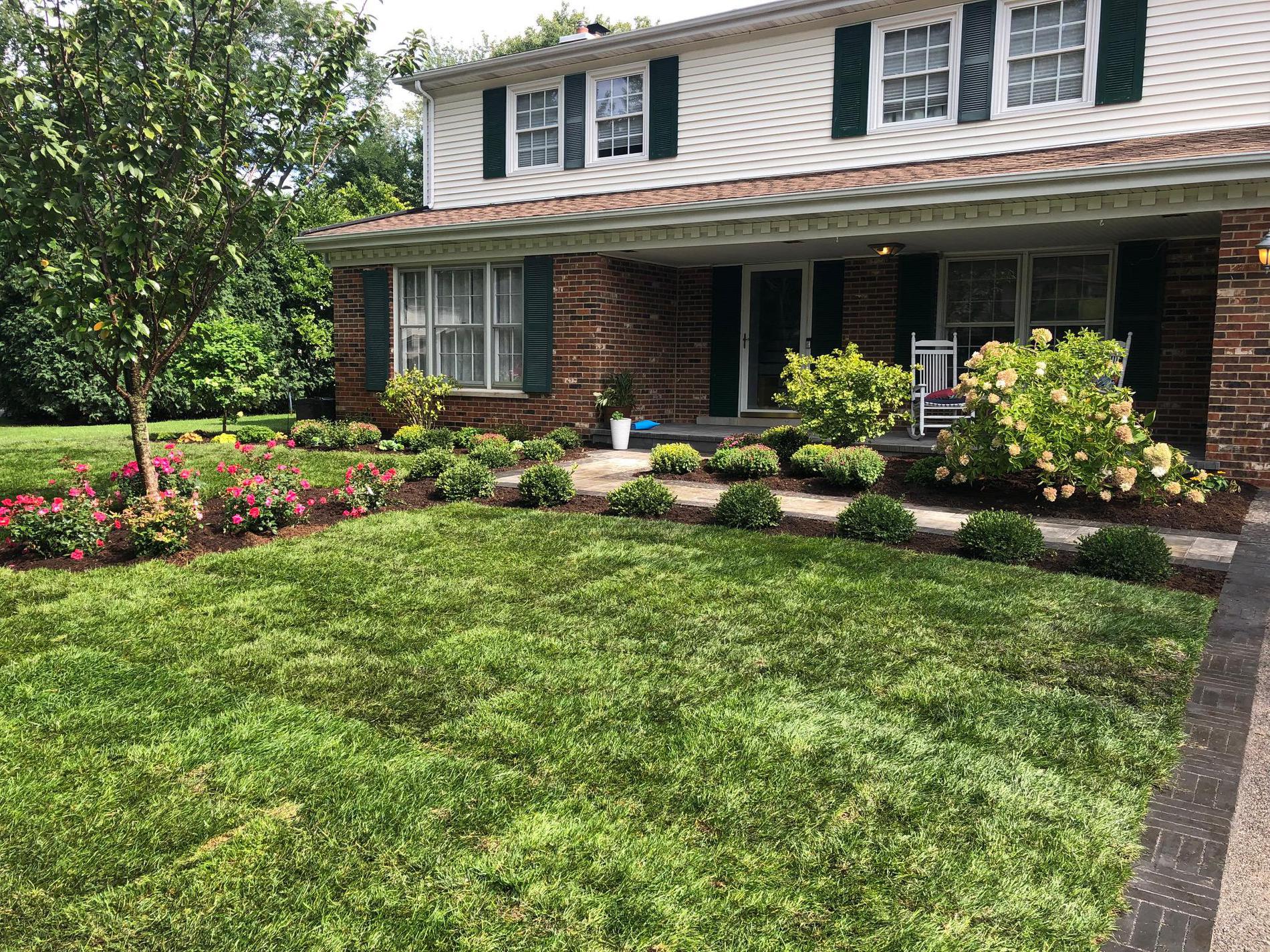 Redesigned front landscape, new brick walkway and porch, and new sod. Northbrook, IL