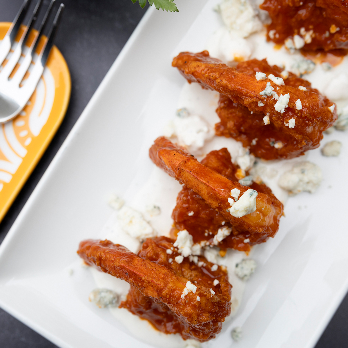 Buffalo Jumbo Shrimp | smothered in buffalo sauce, on bed of blue cheese dressing