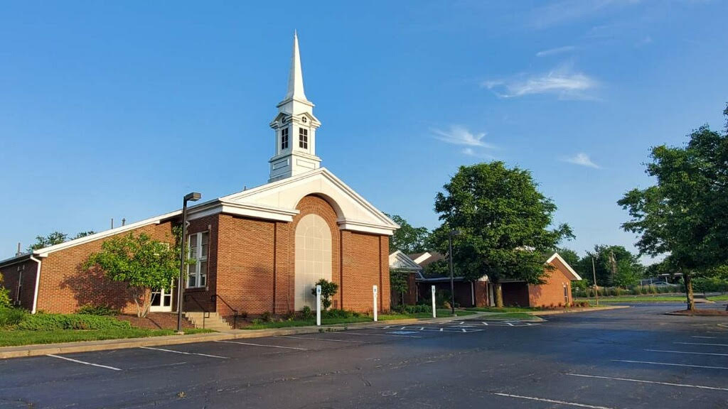 Angled view of the outside of The Church of Jesus Christ of Latter-day Saints building in Shelbyville, KY, with one tree prominently visible