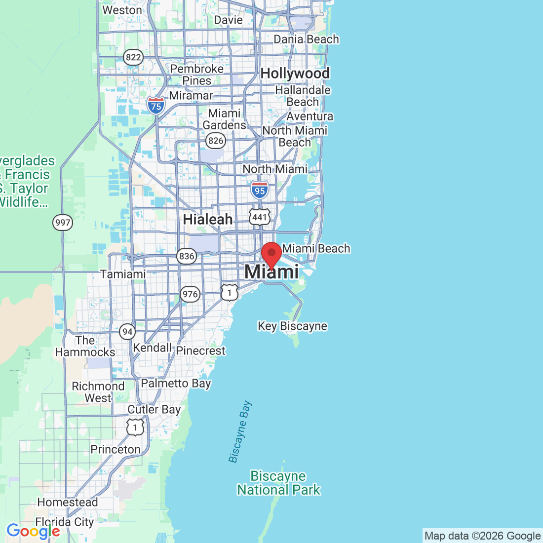 A map showing the city of Miami, Florida, with major roads and surrounding areas like Miami Beach, Key Biscayne, and Biscayne National Park clearly labeled. A red pin marks the approximate location of Miami city center. Highways such as I-95, US-1, and others are visible, along with various neighborhoods and geographical features.