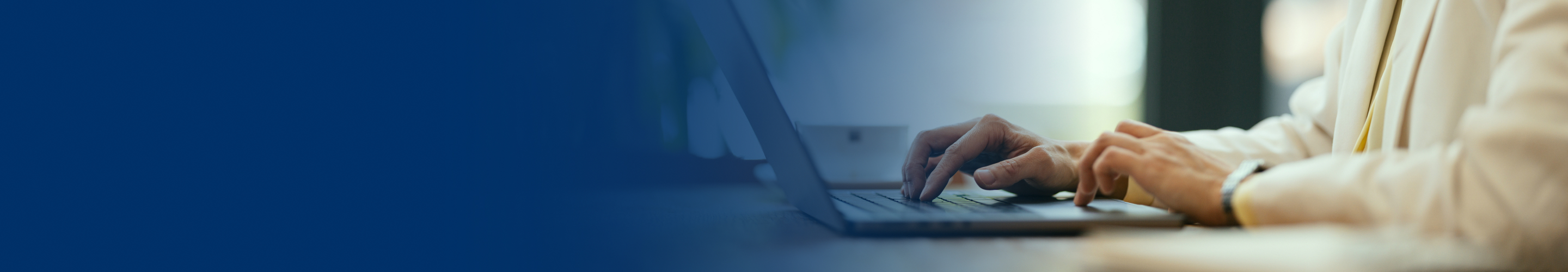 Hands typing on a keyboard.