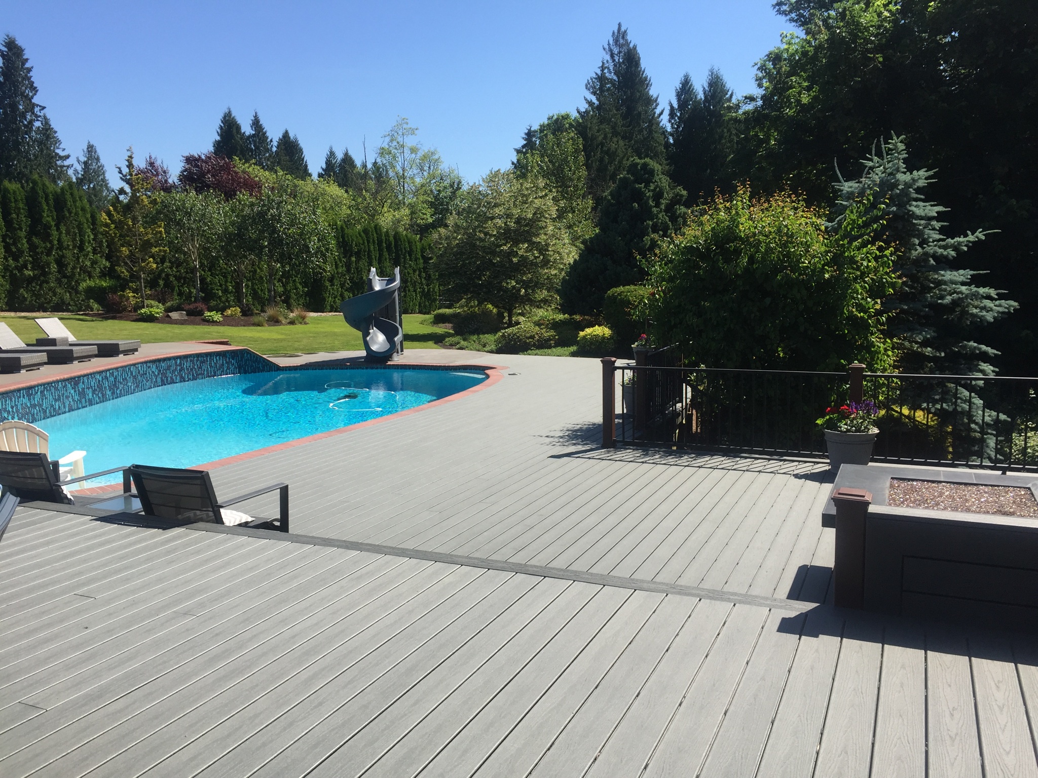 Custom outdoor living and deck remodeling project completed by Jason Smith Construction featuring a luxury composite pool deck, outdoor entertaining space, custom railings, landscaping integration, and backyard home improvement craftsmanship in Clackamas County, Oregon. Designed for Northwest outdoor living and entertaining in Canby, Wilsonville, Oregon City, West Linn, Lake Oswego, and surrounding communities.