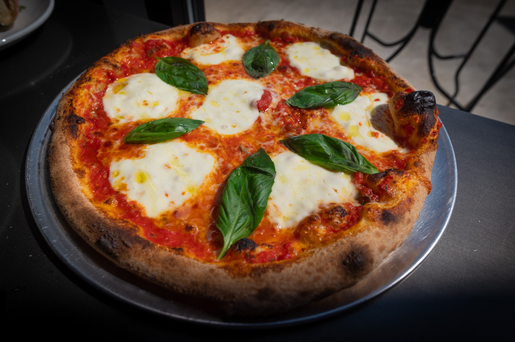 Authentic wood fired pizza with red sauce, buffalo mozzarella EVOO and fresh basil. Fresh ingredients shipped in from Italy for a truly authentic experience.