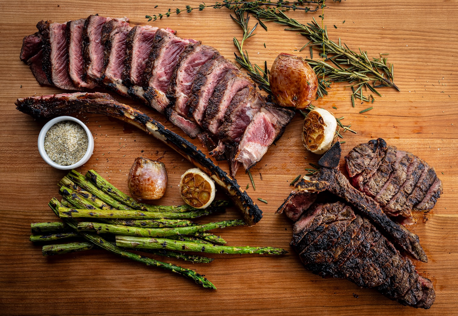 A premium bone-in Tomahawk ribeye steak presented on a platter at Gibsons Bar & Steakhouse, showcasi 