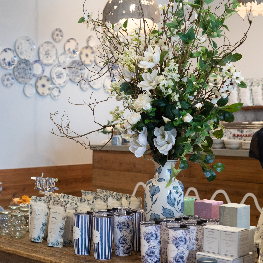 The image depicts a cozy interior with a floral arrangement as the focal point. In the center, there 