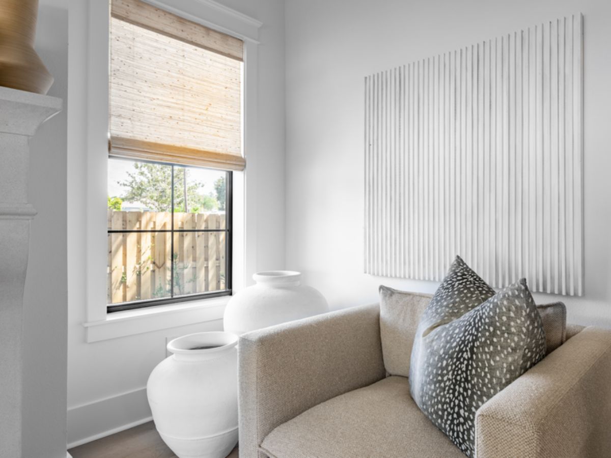 Woven Wood Shades bring warmth and natural texture to this cozy corner,  softly filtering light while adding an organic touch to the space.