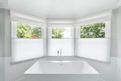 Looking to unwind after a long day of work? We’ve got the perfect solution! We absolutely love how our cellular shades contribute to this bathroom’s sleek, pristine appearance. Our top-down bottom-up cellular shades create the perfect balance of natural light flow and much-needed privacy in your bat