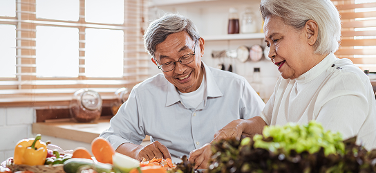 Couple cooking together in their kitchen.