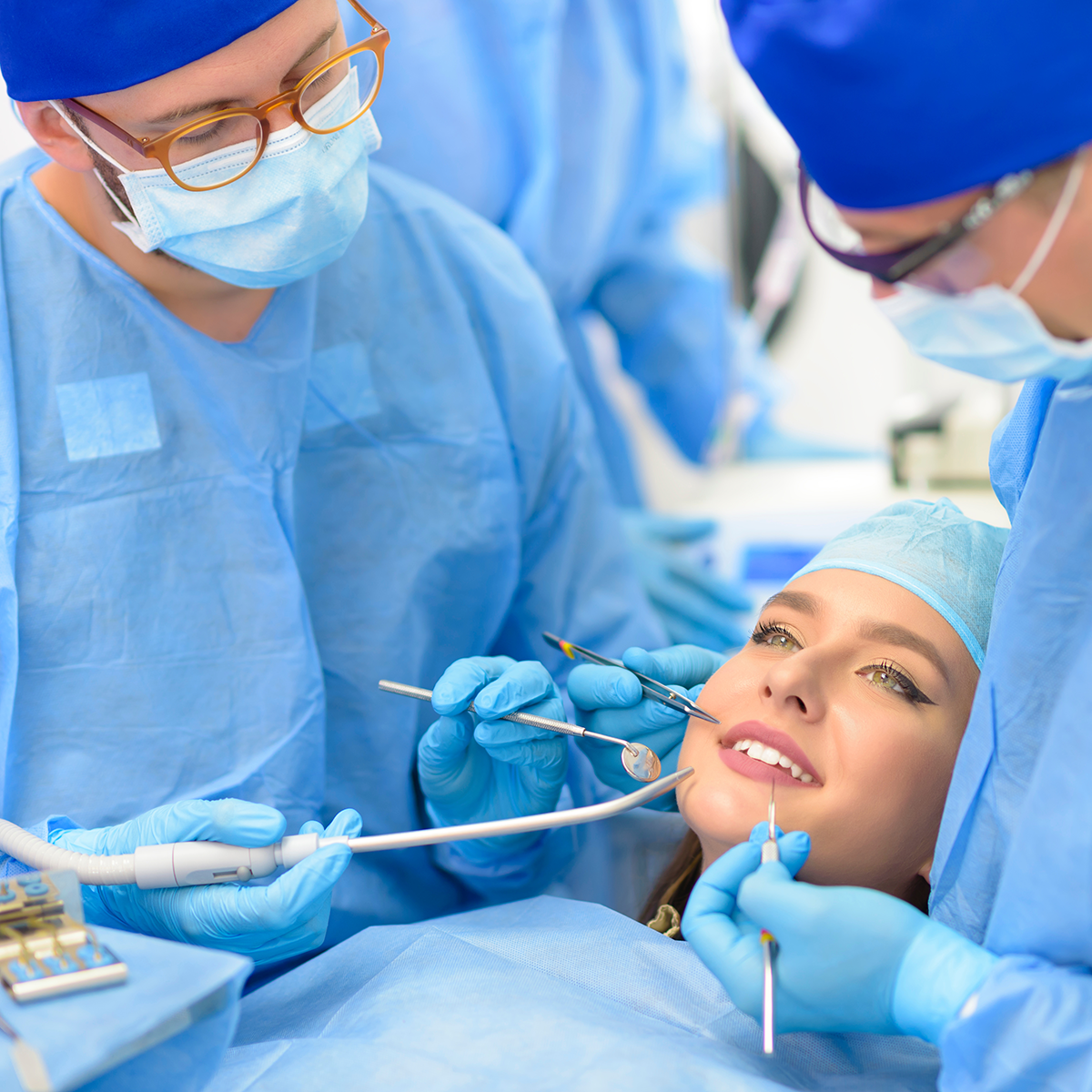 Capture the precision and expertise of an oral surgeon during a complex surgery. This image highlights the focused environment and advanced equipment used in modern oral and maxillofacial surgical practices.