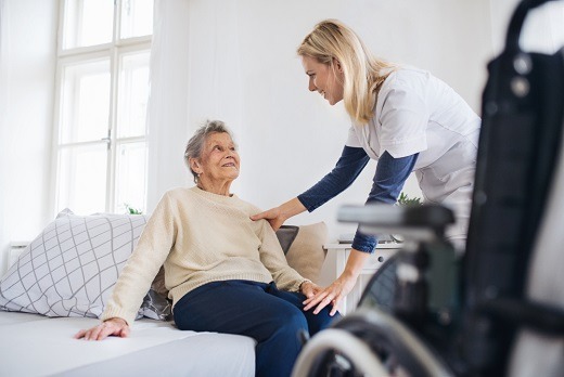 A caregiver provides attentive support to an older adult in a home setting, assisting with mobility and comfort. This image reflects the compassionate, hands-on care offered by 7 Sisters Home Care to clients in Mount Vernon who need dependable daily assistance.