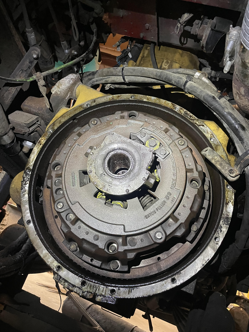 A top-down, close-up view of a heavy-duty Eaton Fuller clutch assembly installed within a vehicle's  