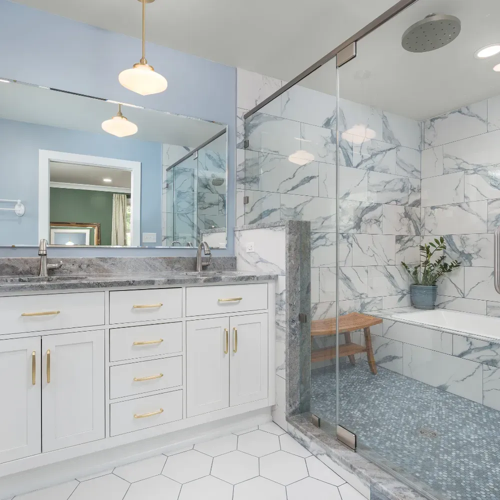 Luxury bathroom remodel in Central North Carolina featuring a custom double vanity, marble countertops, tiled shower walls, and modern fixtures. Completed by a professional bathroom remodeling contractor serving the Badin Lake area.