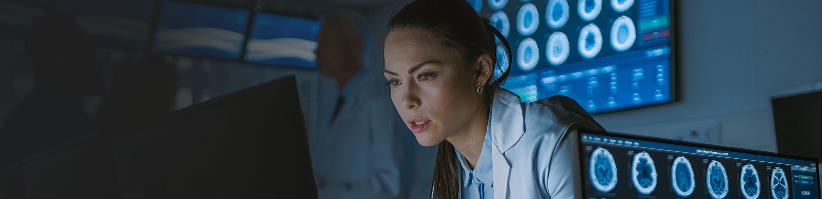 Professional woman looking at screens.