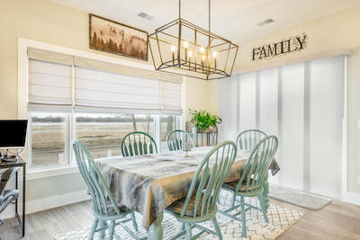 Woven wood shades complement the rustic charm of this home beautifully. They offer a blend of practicality and style, with the added convenience of motorized options. Control your light and privacy with the touch of a button!