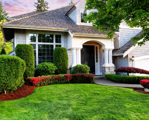 House with a beautiful landscape garden design by M & D Design & Build