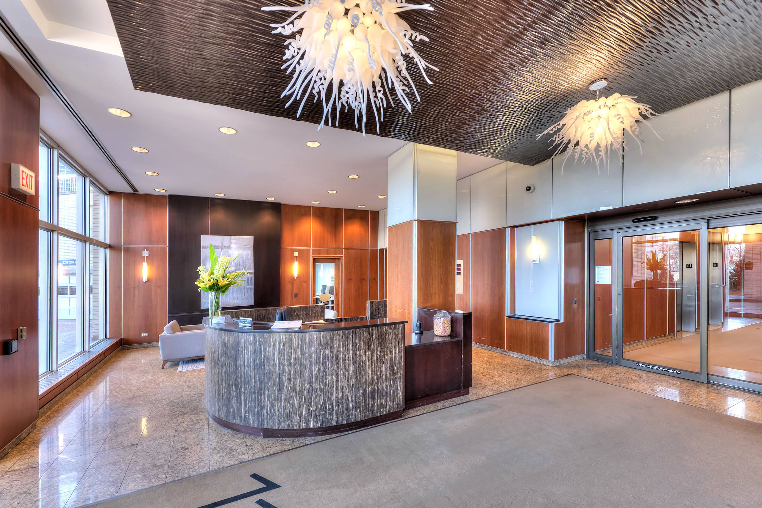 Modern lobby with curved reception desk and decorative lighting 