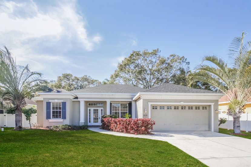 Charming home with a covered patio and two-car garage at Invitation Homes Tampa.