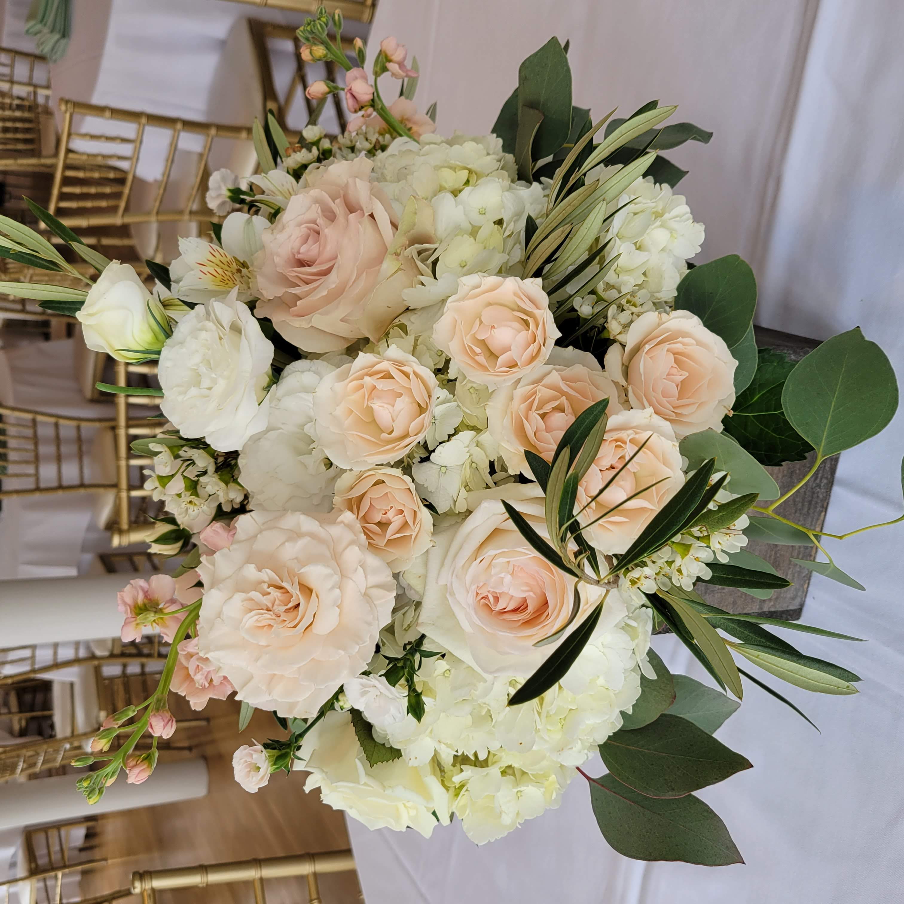 March wedding reception flower centerpiece at Seacliff Manor, Seacliff, NY. Neutral color palette, rustic, and garden style table centerpiece in a wood square container.
